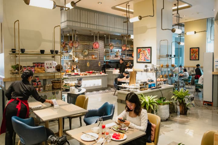 Brilliant Cebuと提携しているサミットホテルの学校内のレストラン/食堂。ブッフェスタイルの食事スペースと、食事をする学生。