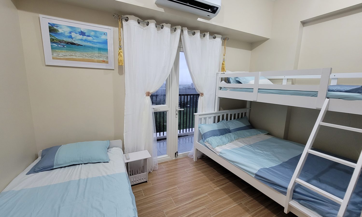 PIAの3人部屋(家族用)。二段ベッドとシングルベッド、白いカーテンの部屋