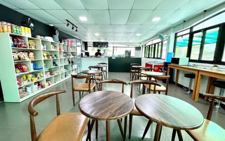 English Fella 1のカフェ「Cafella」。売店の棚とテーブル席がある